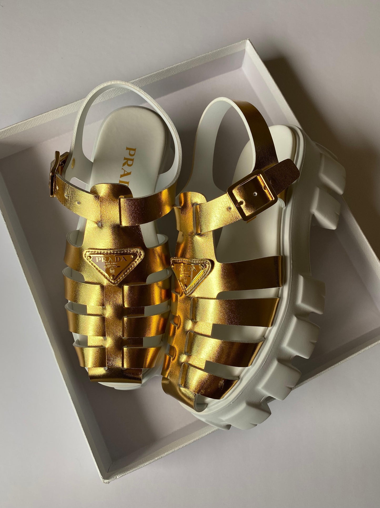 Prada sandals. Gold